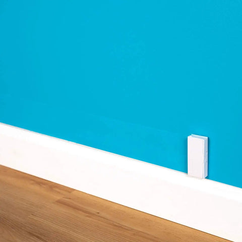 Ultra Flat Adhesive Speaker Wire 16 AWG 2 Conductor, 50 Ft White Spool on blue wall, Ghost Wire 2.0, paint-friendly installation