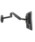 Badass Aluminum Monitor Wall Mount With Mechanical Spring Arm For 17 To 27 Inch Screens shown mounted with full motion arm extended.