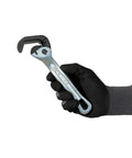 Top Shelf Nine Inch Compact Pipe Wrench Built Like A Tank For Killer Grip On Half To One Inch Fittings Chrome Plated held in gloved hand.