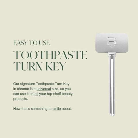 Side view of a chrome toothpaste turn-key metal tube squeezer with long handle