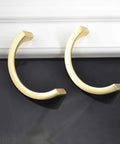 Two Pair Cabinet Hardware Handles In Golden Copper Brushed Gold Finish With Double Hole Mounting displayed on black surface