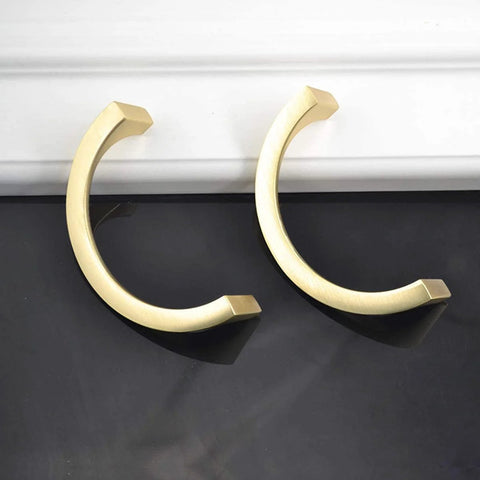 Two Pair Cabinet Hardware Handles In Golden Copper Brushed Gold Finish With Double Hole Mounting displayed on black surface