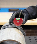 Strong Hand Tools MPCH250 magnetic pipe centering head with red dial on a pipe, gloved hand.