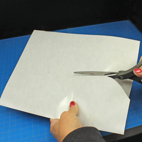 Person cutting Magnetically Receptive Vinyl Sheet For Magnetic Miniatures Storage, 3 Pack, 0.025 Inch Thick, Adhesive Backed, Letter Size.
