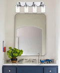 Sleek Chrome Finish Four Light Bathroom Vanity Light Fixture With Clear Glass Shades above modern bathroom sink and mirror.