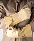 Person wearing stick welding gloves heat resistant with pro grade premium grain cowhide leather heavy duty cotton lining.