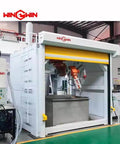 Front view of white WIN GWIN waterjet cutting machine enclosure with orange robotic arm inside.