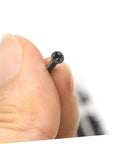 Close-up of a flat-head screw from the Miniature Screw Set With 18 Sizes, held by fingers, showing detail and texture.