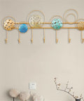Heavy Duty Wrought Iron Wall Decor With A Dope Partition Rack And Coat Hook This Hand Painted Blue Gold Storage Organizer Sets An Awesome Vibe While Keeping Things Sleek on a wall with circular metal designs and hooks.