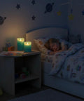 Turquoise Real Wax Flameless Candles Set Of 3 in a child's room, teal LED pillars with realistic glow, creating a chill beachy vibe.