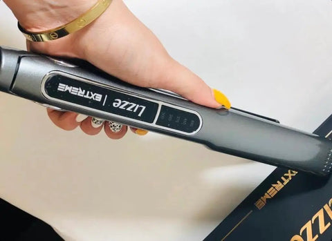 Close-up of Extreme Nano Titanium Hair Straightener With Floating Plates, Fast Heating, held in hand