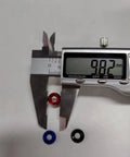 Close-up of caliper measuring M4 washers, visible in multiple colors, showing 9.82mm. 60Pcs M4 Counterbore Washers Anodized Aluminum Alloy Black For RC FPV Drones PCs Toys Mechanical Accessories Head Washers Gaskets Cup Shims Screw Hardware