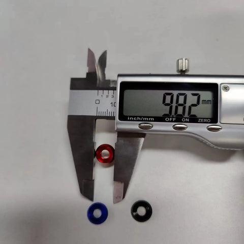 Close-up of caliper measuring M4 washers, visible in multiple colors, showing 9.82mm. 60Pcs M4 Counterbore Washers Anodized Aluminum Alloy Black For RC FPV Drones PCs Toys Mechanical Accessories Head Washers Gaskets Cup Shims Screw Hardware