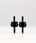 Front view of a pair of black PA66 automotive spring check valves