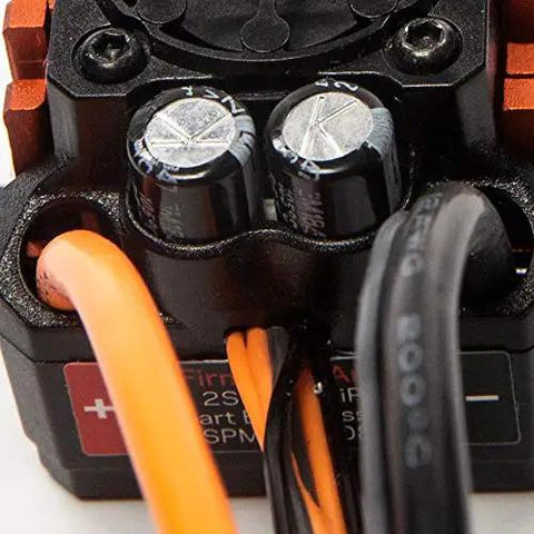 Close-up of Firma 85A Brushless Smart ESC And 3300Kv Sensorless Motor Combo's wiring and capacitors, SPMXSEMC01 black housing