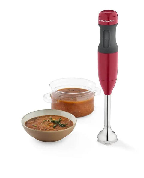 Kickass 2 Speed Hand Blender With Secure Locking Arm And Razor Sharp Stainless Steel Blade For No Sweat Puree And Soup Prep In Bold Empire Red Colorway ready fast, next to bowls of soup.
