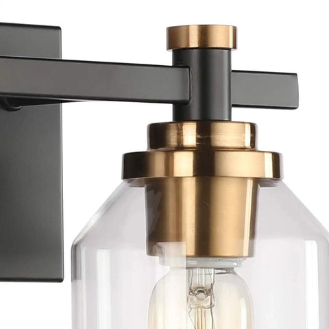 Close-up of Slick Two Light Industrial Style Bathroom Vanity Light showing matte black frame and brushed bronze copper accents