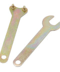 Angle grinder chuck kit wrenches: two zinc-plated metal spanners, one with studded end and one open-ended.