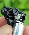 M20 DC Worm Gear Motor Operating At 3V To 5V Serving Up Smooth 150 RPM Punch Inside A Compact Turbo Reduction Box close-up showing gears and housing.