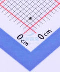 Close-up of black SMD ESD protection diode DFN0603-2 on measurement grid for scale
