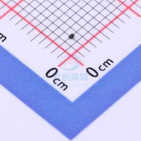 Close-up of black SMD ESD protection diode DFN0603-2 on measurement grid for scale
