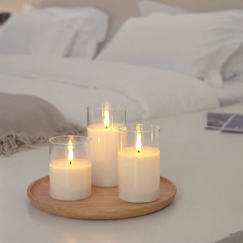 Clear Glass Flameless Candles With Timer And Remote Control Battery Powered LED Pillar Candles Set Of 3 In White Wax on a tray
