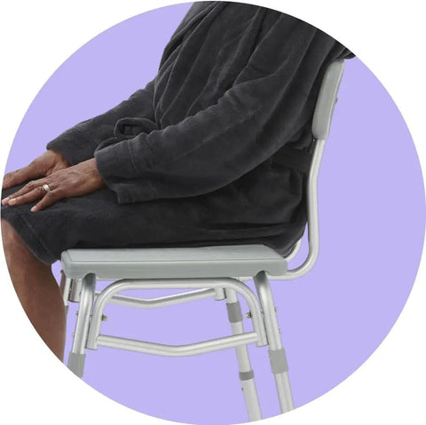 Side view of person seated on Transfer Bench Shower Chair With Backrest Adjustable Seat From 18 to 22.5 Inches Durable Aluminum Frame