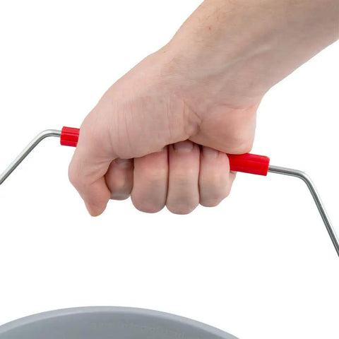 Hand gripping the red bail of a Heavy Duty 14 Quart Gray Round Pail For Pro Cleaning With Printed Measurement Lines And Solid Grip Bail.