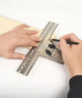 Person using Eight Position Cabinet Pull Drill Template For Doors And Drawers Metal Mounting Template with direct drilling on wood