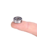 Donepart R4-2RS ball bearing, 1/4 x 5/8 x 0.196 in, double-sealed metal bearing held on fingertip