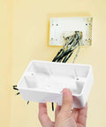 Low Profile Wall Outlet Box For Easy Home Wiring Install No Fuss Junction Box Made From Durable ABS Plastic For Safe Reliable Electrical Connection Everyday Use, white ABS wall box being held