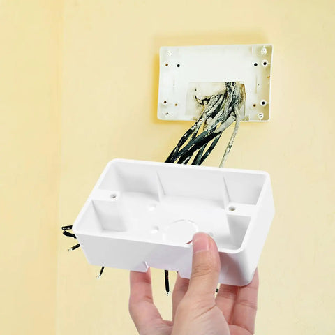Low Profile Wall Outlet Box For Easy Home Wiring Install No Fuss Junction Box Made From Durable ABS Plastic For Safe Reliable Electrical Connection Everyday Use, white ABS wall box being held