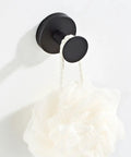 Heavy Duty Black Stainless Steel Wall Hook with white loofah hanging, perfect for organizing jackets and gear in your home.