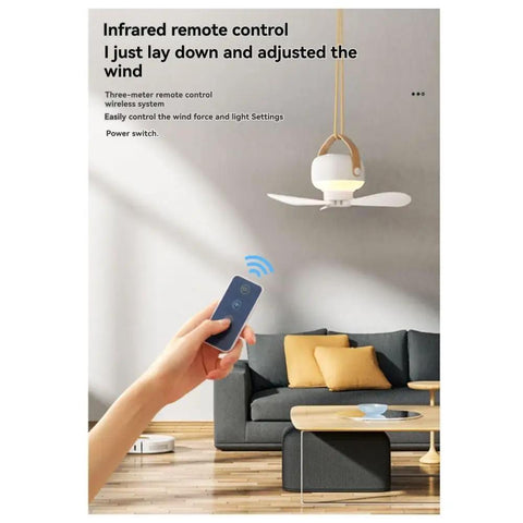Hand holding remote control for kousoer Ceiling Fans Quiet Remote USB 7200mAh in a modern living room.