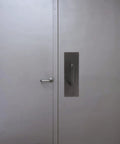 304 Stainless Steel Push Pull Door Handle With Screws For Fireproof Passages installed on a metal door.