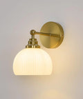 Feasey Vintage Milk Glass Globe Wall Sconce, Mid Century Ribbed Glass Light with brass fixture and white ribbed glass shade.
