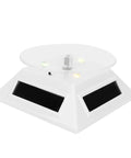 Xhtllo Electric Led Light Solar Powered Rotating Turntable Display Stand For Jewelry with clear acrylic top and solar panels.