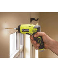 Using Compact 4V Lithium Screwdriver With One Quarter Inch Hex Chuck Two Speed Gearbox on wall, visible drill bit and rubber grip