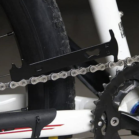3 In 1 Bicycle Chain Tool Set With Chain Breaker Wear Checker And Chain Link Plier For City E Bike Mountain MTB And Racing Bikes Pro Grade Heavy Duty Stainless Steel With Non Slip Grip Go To Maintenance Kit showing wear checker in use on bike chain.