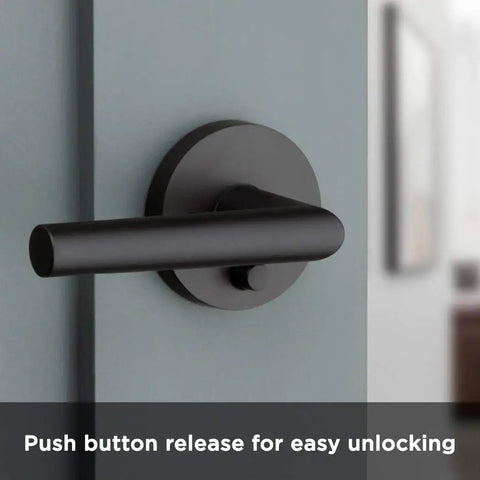 Milan Matte Black Iron Door Lever, Dope Modern Slim Round Privacy Handle, shown on interior door with push button release