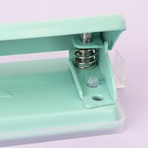 Close-up of mint 2 Hole Puncher with Waste Tray, 10 Sheet Capacity, featuring metal construction and non-slip base for office use.