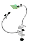 Soldering Third Hand Tool With Tabletop Clamp, Two Nickel Plated Flexible Arms And Rotatable Alligator Clips holding a circuit board.