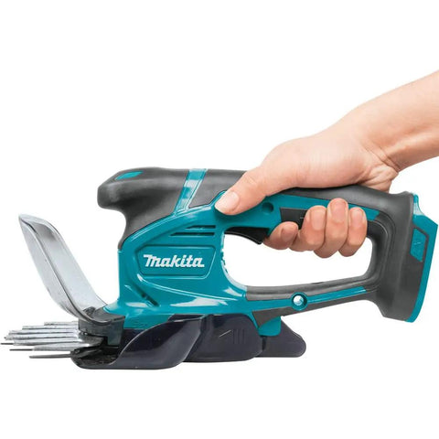 Hand holding 18V LXT Cordless Grass Shear With Hedge Trimmer Blade, Go-To Yard Tool, 2-In-1 Quick Blade Change, Up To 3 Hours Runtime