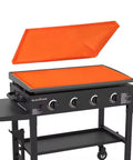 Rock Solid Thick Silicone Griddle Mat For Blackstone 36 Inch Cooktop, orange mat on Blackstone grill, 35.82 by 21.65 inches.