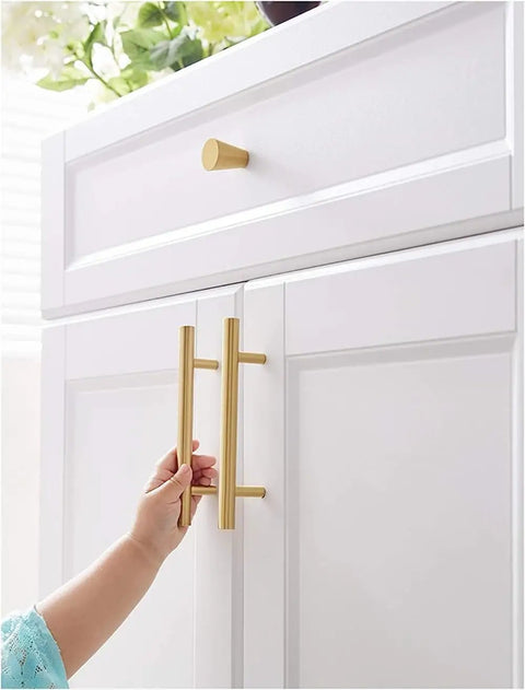 Child's hand holding Solid Brass Cabinet Pulls Set Of 10 Round Brushed Brass Handles For Cabinets And Drawers Modern Kitchen Hardware