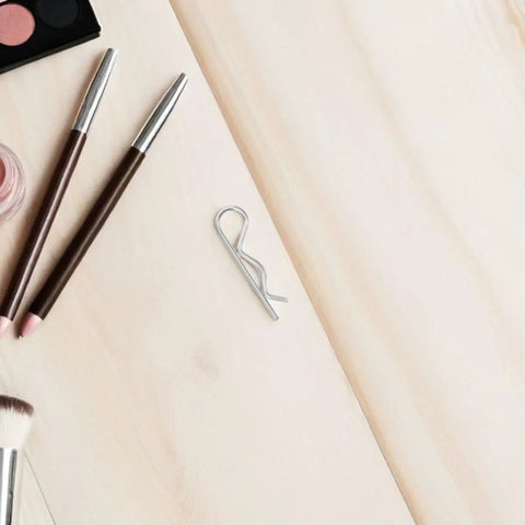 Sturdy 8 Pack R Shape Hitch Pins Made From Industrial Stainless Steel For Secure Mechanical Assembly And Fastening Lock Applications That Are Easy To Install And Super Durable For Any Heavy Duty Task on a wooden surface with beauty products.