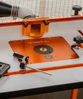 O'SKOOL router template bushing guides set on orange router-table insert plate with visible logo and metal hardware