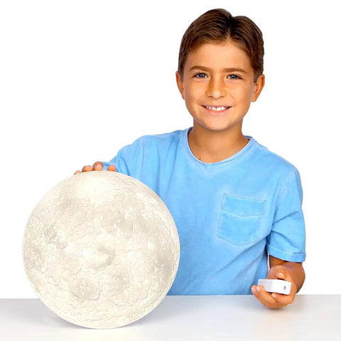 Child holding Moon In My Room Light Up Lunar Phases Kit With Remote Control, showcasing realistic moon detail.