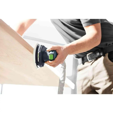 Person using 6 Inch Random Orbital Sander With Stepless Speed Control And Constant Speed Under Load EC Technology on wooden surface.