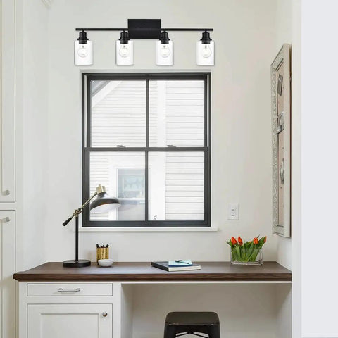 4 Light Modern Bathroom Lighting Fixtures in Matte Black Finish with Clear Glass Shades Above Desk